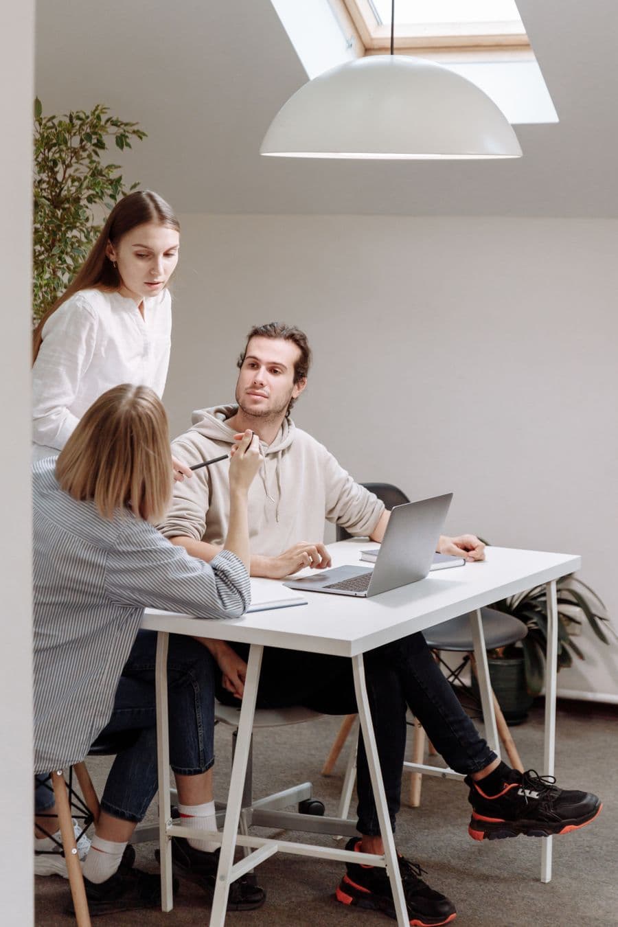 Small team working around a table in a bright office